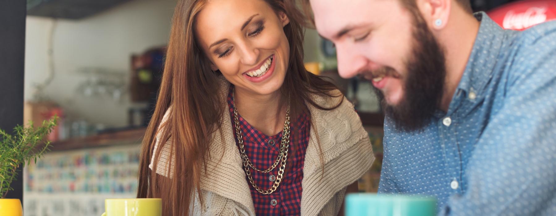 a man and a woman looking at a laptop
