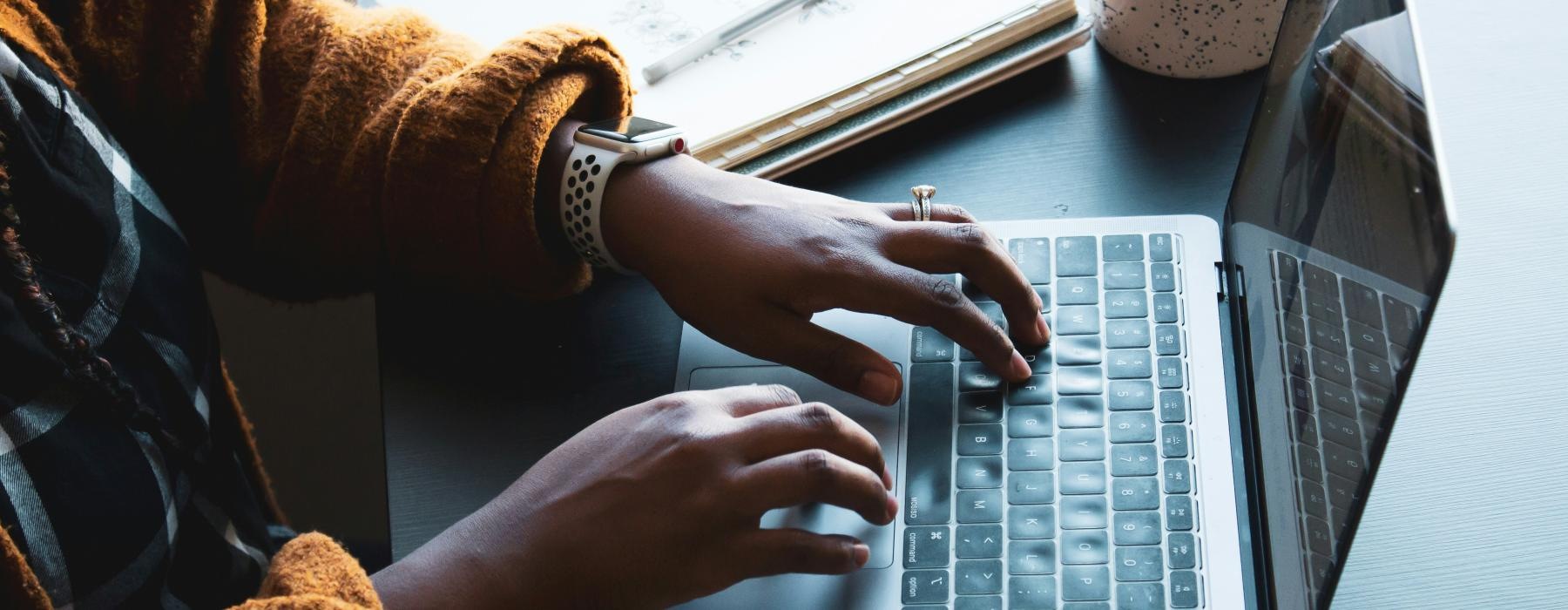 a person typing on a laptop